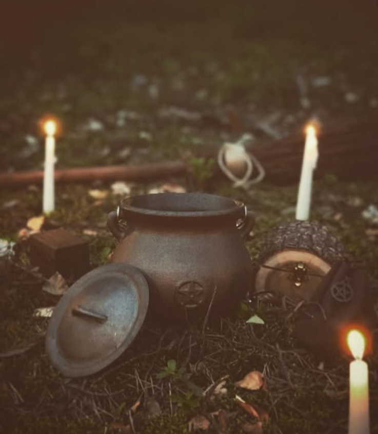 Ritual cauldron and candles in nature